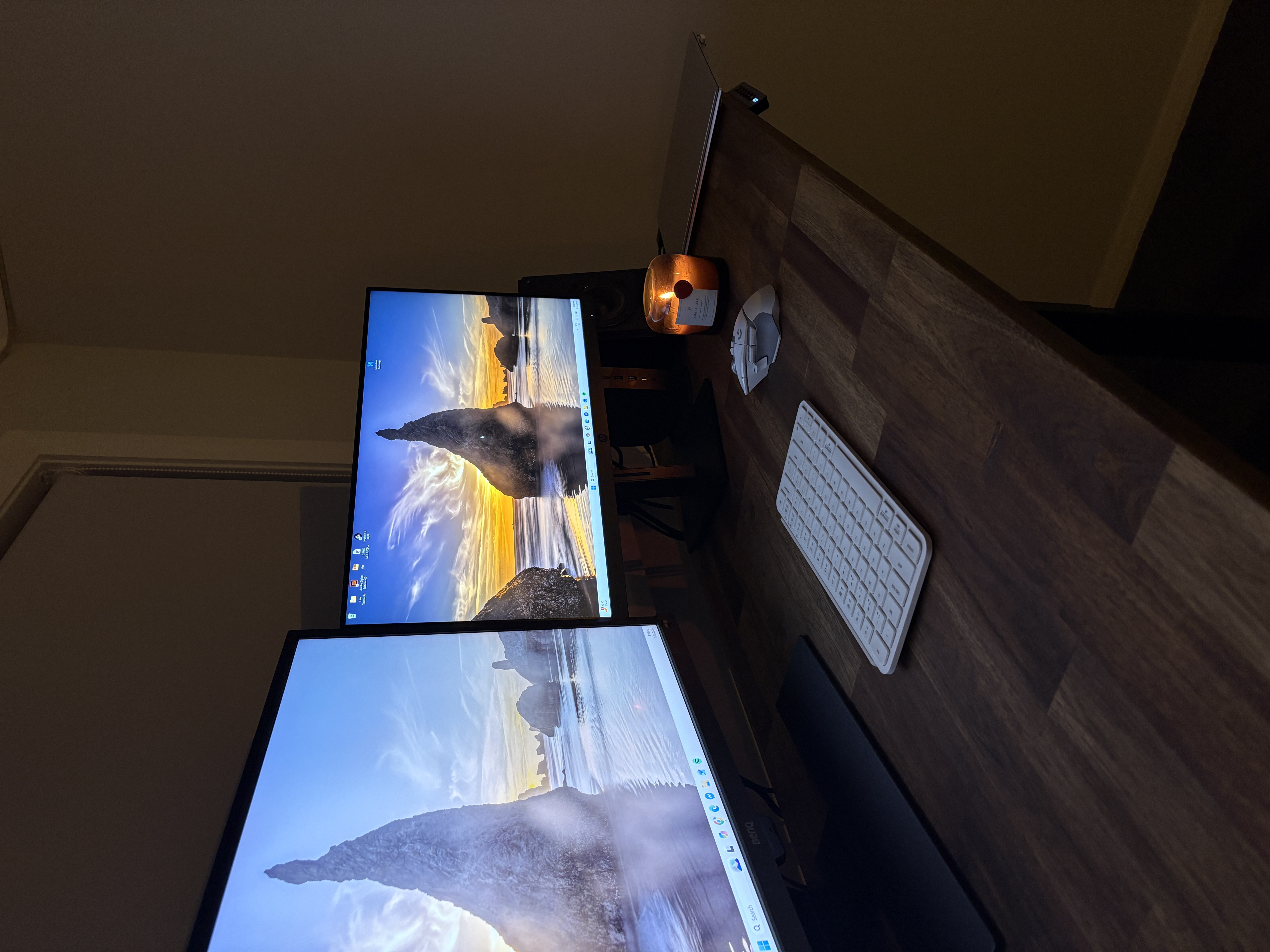 Large timber desktop with two monitors and accessories